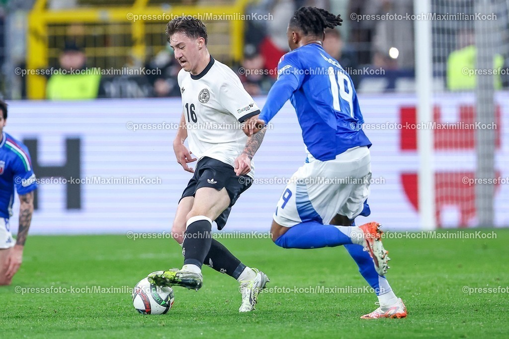 DFB23032501042 | 23.03.2025, Fußball, Viertelfinale UEFA Nations League, Deutschland - Italien, Signal Iduna Park, Saison 2024 2025: Angelo Stiller (GER #16) im Zweikampf gegen Iyenoma Destiny Udogie (ITA #19) DFB regulations prohibit any use of photographs as image sequences and or quasi-video.