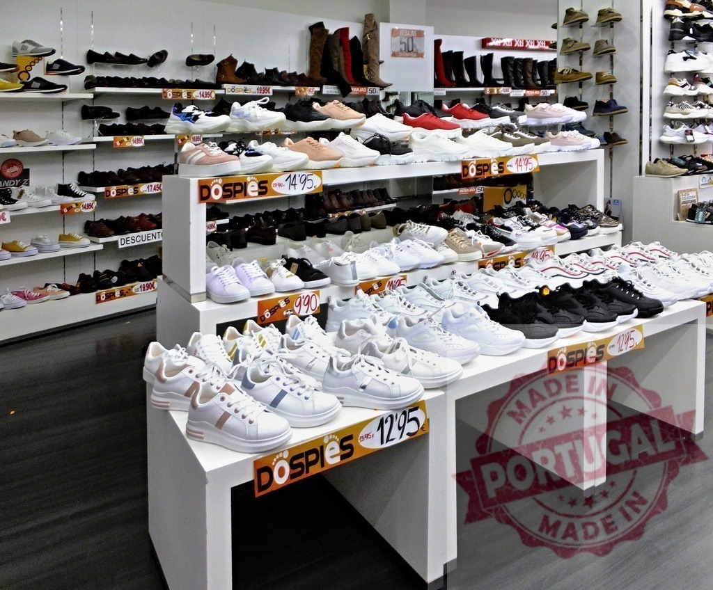 Sneakers and shoes on display inside retail store | Selection of footwear including sneakers and boots on shelves inside a shoe shop - Realized with Pictrs.com