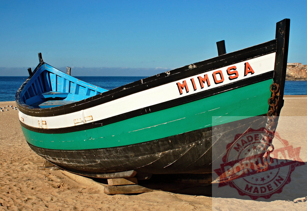 Fishing boat Mimosa resting on a sandy beach | Fishing boat Mimosa sitting on the sand with the ocean and blue sky in the background - Realized with Pictrs.com