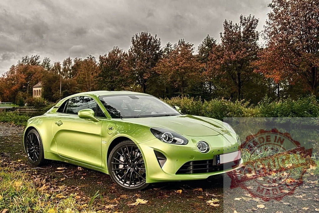 Alpine A110 sports car parked by calm pond in autumn | Alpine A110 sports car showing modern automotive design parked by a pond with autumn trees - Realized with Pictrs.com