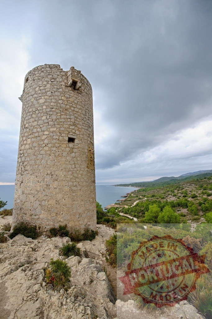 Old watchtower overlooking the Mediterranean coast in Spain under cloudy sky | Ancient stone watchtower dominating the coastal landscape of the Mediterranean Sea in Spain, under a dramatic cloudy sky - Realized with Pictrs.com