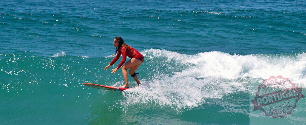 Female surfer riding a wave in the ocean | Surfer maneuvering on a surfboard, riding a wave in the ocean - Realized with Pictrs.com