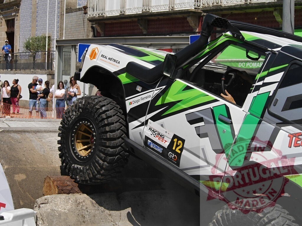 Powerful 4x4 vehicle climbing a concrete obstacle during an off-road competition in Portugal | Off-road vehicle overcoming a challenging obstacle during a race, showcasing power and skill - Realisiert mit Pictrs.com