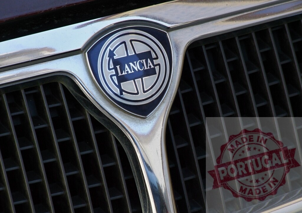 Lancia car front grille and emblem close up | Lancia emblem on a vintage car grille, symbolizing Italian automotive heritage and design - Realisiert mit Pictrs.com