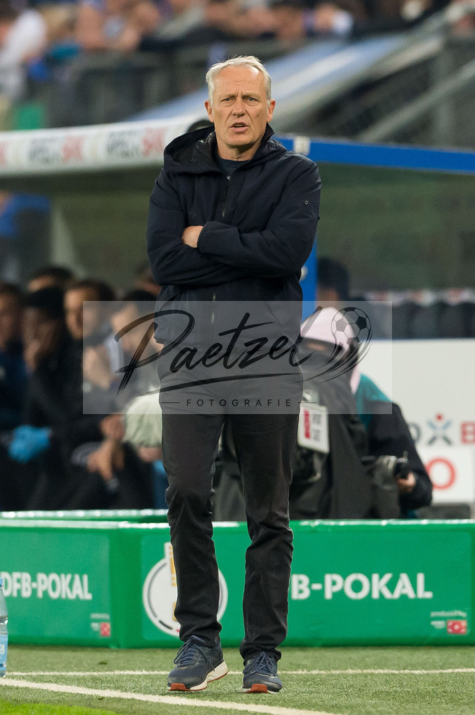 HSVSCF20220419_309 | Fussball, Herren: Trainer Christian Streich (SC Freiburg) schaut beim DFB-Pokal-Halbfinalspiel zwischen Hamburger SV und SC Freiburg im Volksparkstadion am 19.04.2022 in Hamburg, Deutschland.DFB / DFL REGULATIONS PROHIBIT ANY USE OF PHOTOGRAPHS AS IMAGE SEQUENCES AND/OR QUASI-VIDEO. - Realisiert mit Pictrs.com