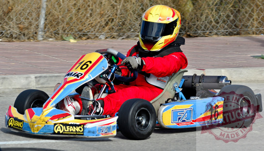 Kart driver racing on a track during competition | Professional kart driver racing on a track during competition or training - Realisiert mit Pictrs.com