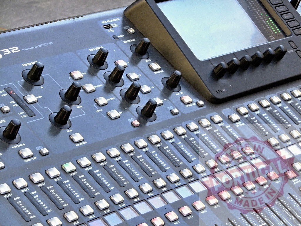 Professional digital audio mixing console showing knobs, faders and buttons | Close-up of a digital audio mixing console featuring knobs, faders, buttons and a screen, ideal for music production, broadcasting or live events - Realized with Pictrs.com
