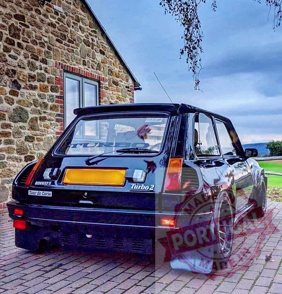 Renault 5 Turbo 2 classic rally car parked | Renault 5 Turbo 2 standing on a paved driveway in front of a stone building - Realized with Pictrs.com