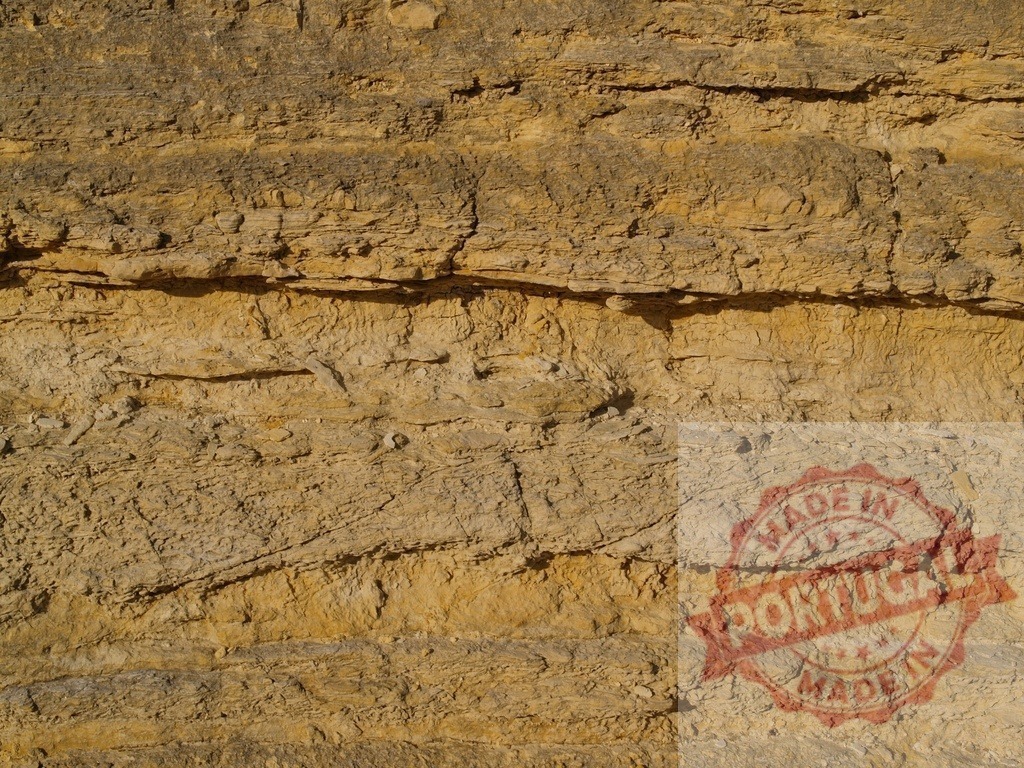 Sedimentary rock face showing geological strata creating a natural pattern | Close-up view of a sedimentary rock face, revealing distinct geological strata that form a captivating natural pattern - Realized with Pictrs.com