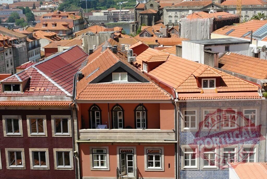 Porto city old town historic buildings rooftops. Porto - Portugal | Porto old town houses with traditional ceramic roof tiles and blue azulejo facade - Realized with Pictrs.com