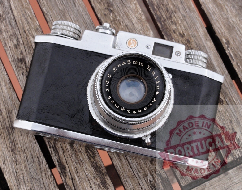 Halina film camera resting on wooden background | Halina film camera showing vintage analog photography technology - Realized with Pictrs.com