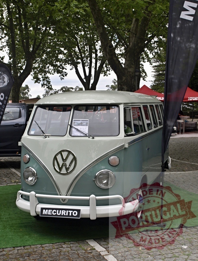 Volkswagen T1 Microbus vintage van on display outdoors | Volkswagen T1 Microbus vintage van parked on cobblestones with trees in background - Realized with Pictrs.com