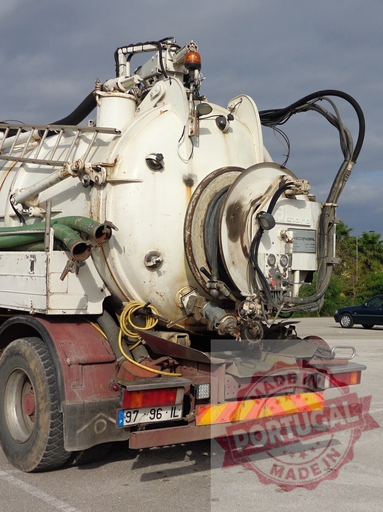 Septic truck vacuuming pump system parked on asphalt | Industrial vacuum truck rear view for sewer and septic cleaning services - Realized with Pictrs.com
