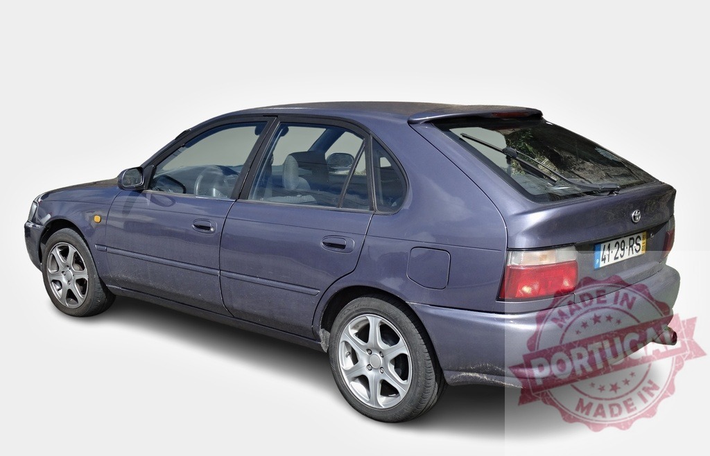 Toyota Corolla showing its rear on white background | Dusty Toyota Corolla with alloy wheels is parked, showing its rear, on a white background - Realized with Pictrs.com