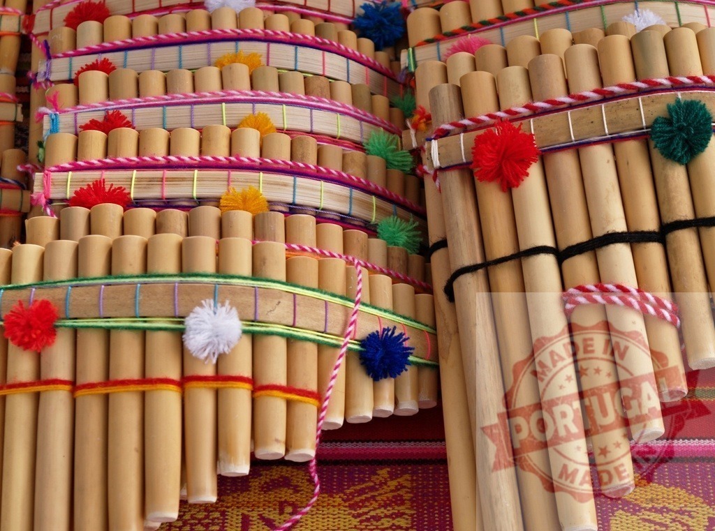 Colorful Andean panpipes showing traditional craftsmanship | Traditional Andean panpipes, handcrafted with bamboo and colorful yarn decorations, showcase the rich musical heritage of the Andes - Realized with Pictrs.com