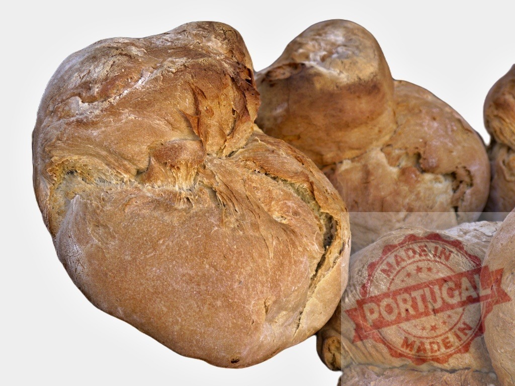 Freshly baked artisan bread loaves on white background | Crusty homemade bread loaves stacked, showing a rustic and traditional bakery product - Realisiert mit Pictrs.com