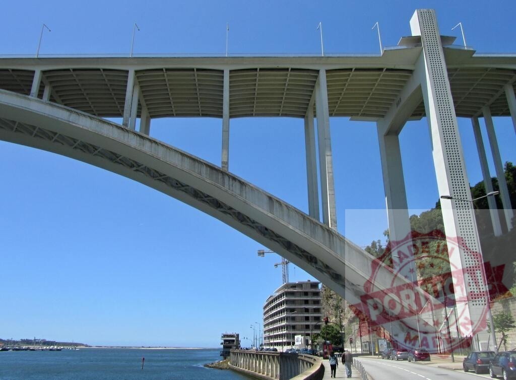 Arrábida Bridge spanning Douro River in Porto, Portugal | Arrábida Bridge a concrete arch structure seen from below with the Douro River - Realized with Pictrs.com