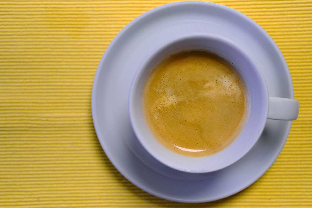 Kaffeetasse mit Kaffee auf gelbem Untergrund | Wien, Austria - November 10, 2023: Kaffeetasse mit Kaffee auf gelbem Untergrund - Realisiert mit Pictrs.com