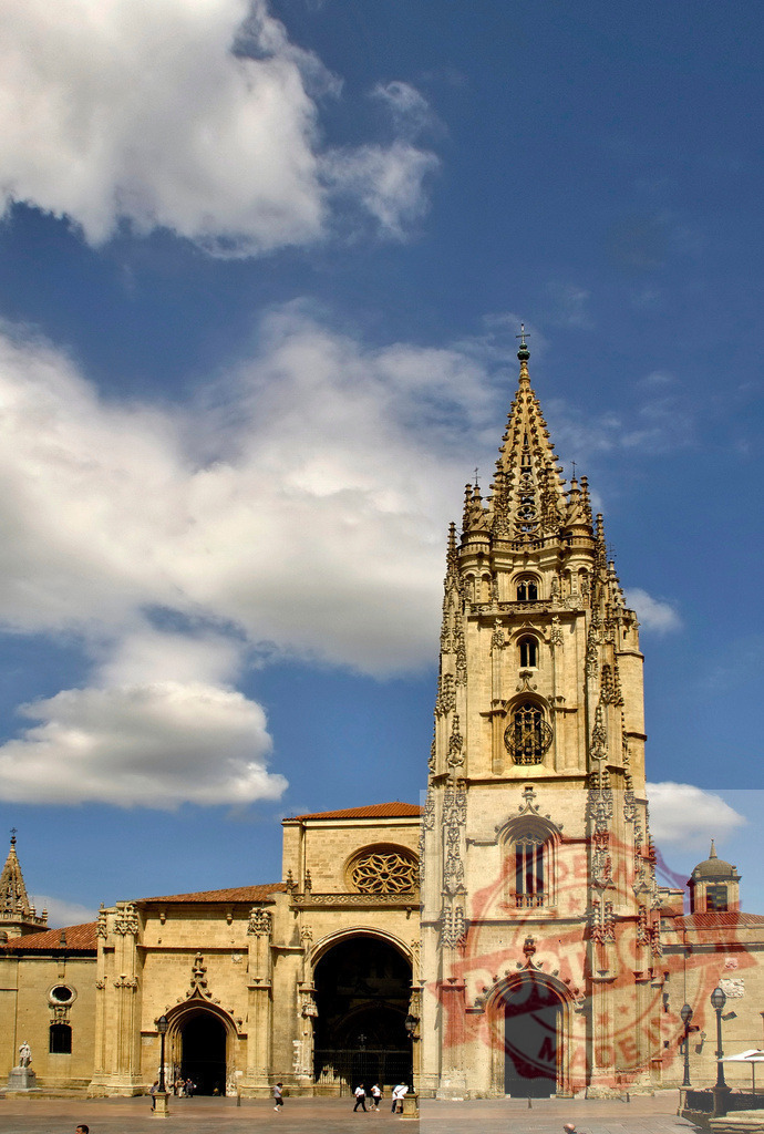 Oviedo Cathedral Gothic spire reaching blue sky | Oviedo Cathedral featuring its intricate Gothic architecture and a tall spire under a blue sky - Realized with Pictrs.com