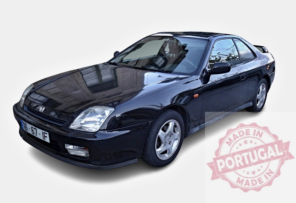 Black Honda Prelude reflecting building is parked on white background | Classic Honda Prelude with building reflection parked on white background - Realized with Pictrs.com