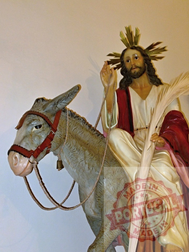 Jesus Christ riding a donkey and holding palm leaf during Palm Sunday | Statue of Jesus Christ riding a donkey and holding palm leaf during Palm Sunday - Realized with Pictrs.com