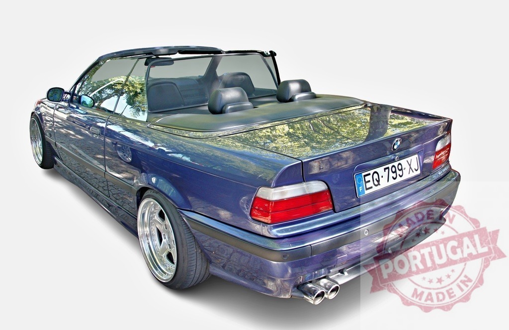 Customized BMW convertible reflecting trees is parked with open roof | Tuned BMW series 3 convertible with custom rims and open roof parked in the sun reflecting trees - Realisiert mit Pictrs.com