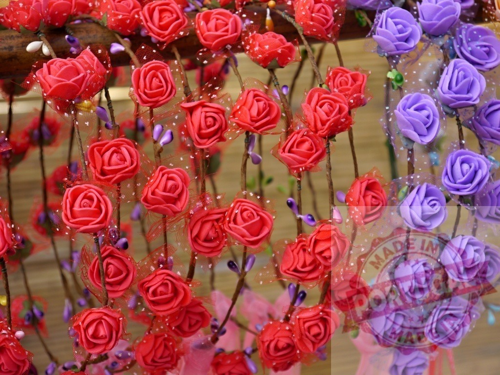 Artificial foam roses creating handmade floral headbands decoration | Artificial foam roses in red and purple colors forming decorative floral headbands - Realisiert mit Pictrs.com