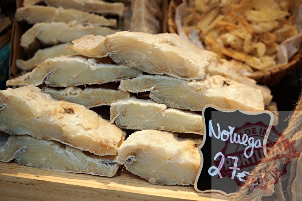 Dried salt cod bacalhau slices from Norway | Stacked bacalhau slices for sale with a price tag from Norway - Realized with Pictrs.com