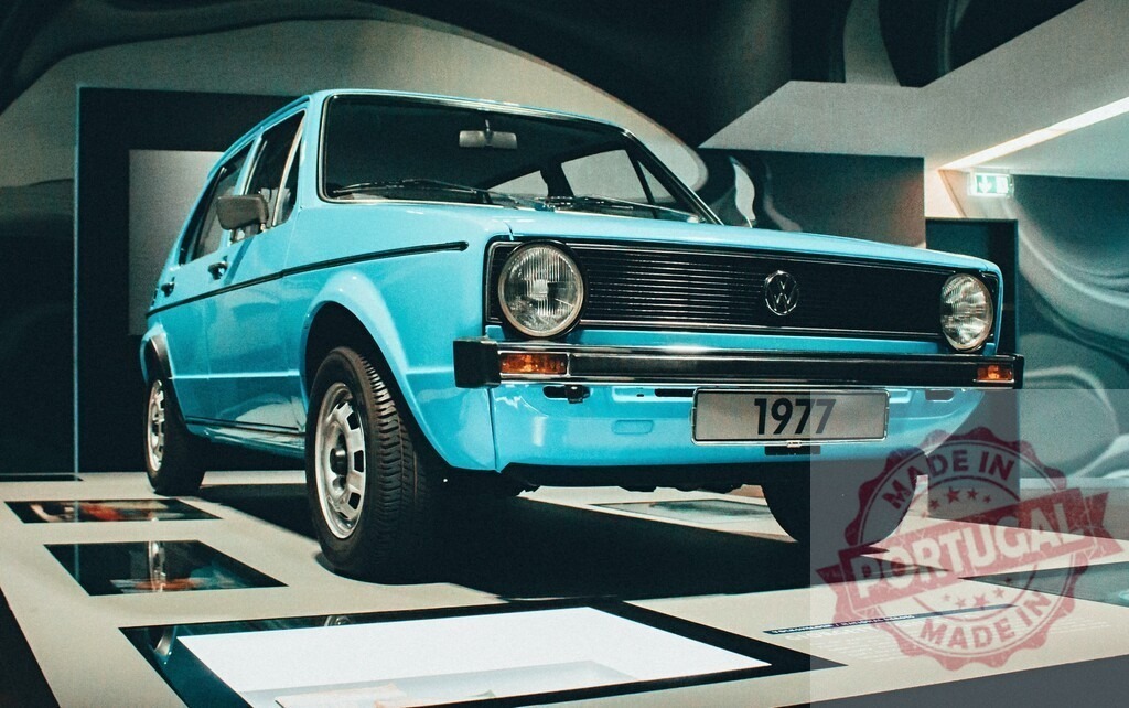 Volkswagen Golf Mk1 blue classic car exhibition | Volkswagen Golf Mk1 displaying vintage automotive design in a modern museum setting - Realized with Pictrs.com