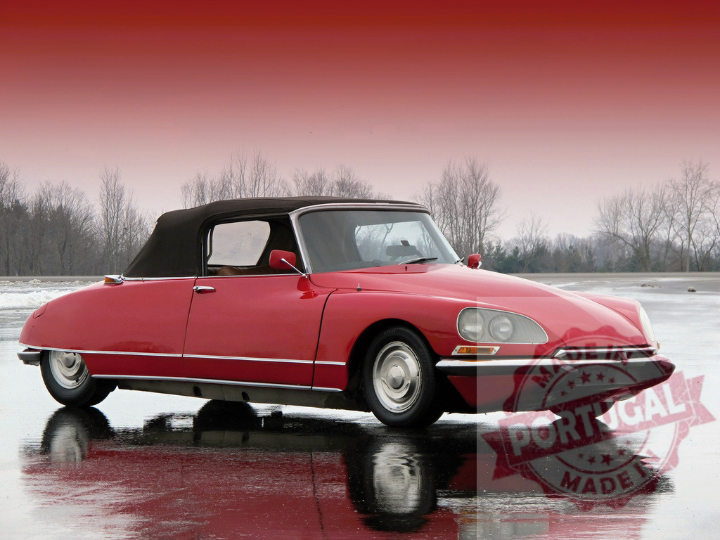 Red Citroën DS Décapotable Reflecting on Wet Asphalt | Classic red Citroën DS convertible parked on wet asphalt with a winter landscape in the background - Realisiert mit Pictrs.com