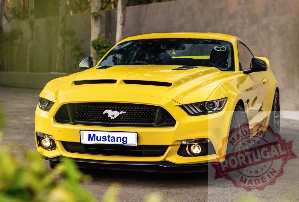 Yellow Ford Mustang parking on paved driveway | Yellow Ford Mustang, a powerful muscle car, parked outdoors on a sunny day - Realized with Pictrs.com