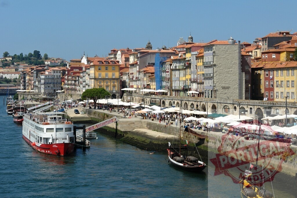 Ribeira district, Porto, Portugal with Douro River boats. Porto - Portugal | Colorful buildings lining the waterfront historic Ribeira district with traditional boats on Douro River - Realized with Pictrs.com