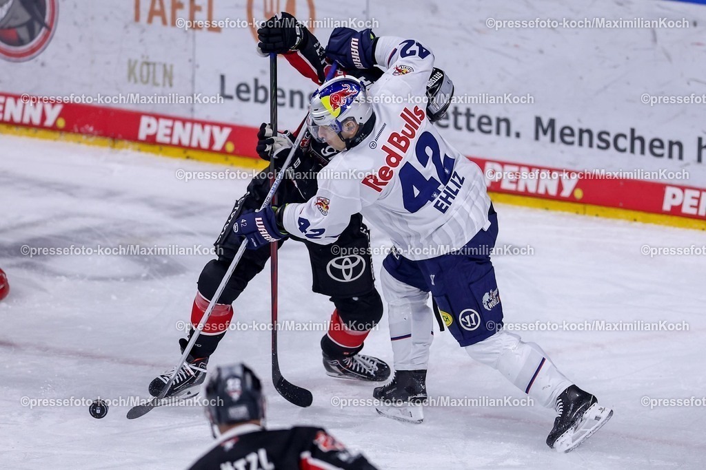 KEC28012501004 | 28.01.2025, Eishockey, DEL, Kölner Haie - EHC Red Bull München, Spieltag 41, Lanxess-Arena Köln: Yasin Ehliz (EHC München #42) im Zweikampf gegen Moritz Müller (Kölner Haie #91)