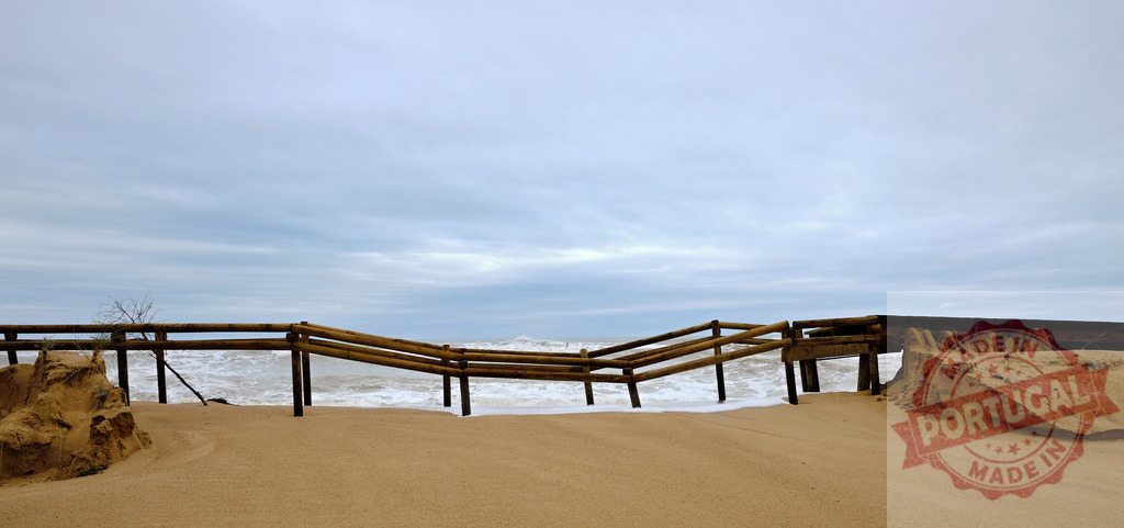 Beach infrastructure collapsing from storm surge and erosion | Beach boardwalk breaking and sand eroding from powerful storm waves under a cloudy sky - Realized with Pictrs.com