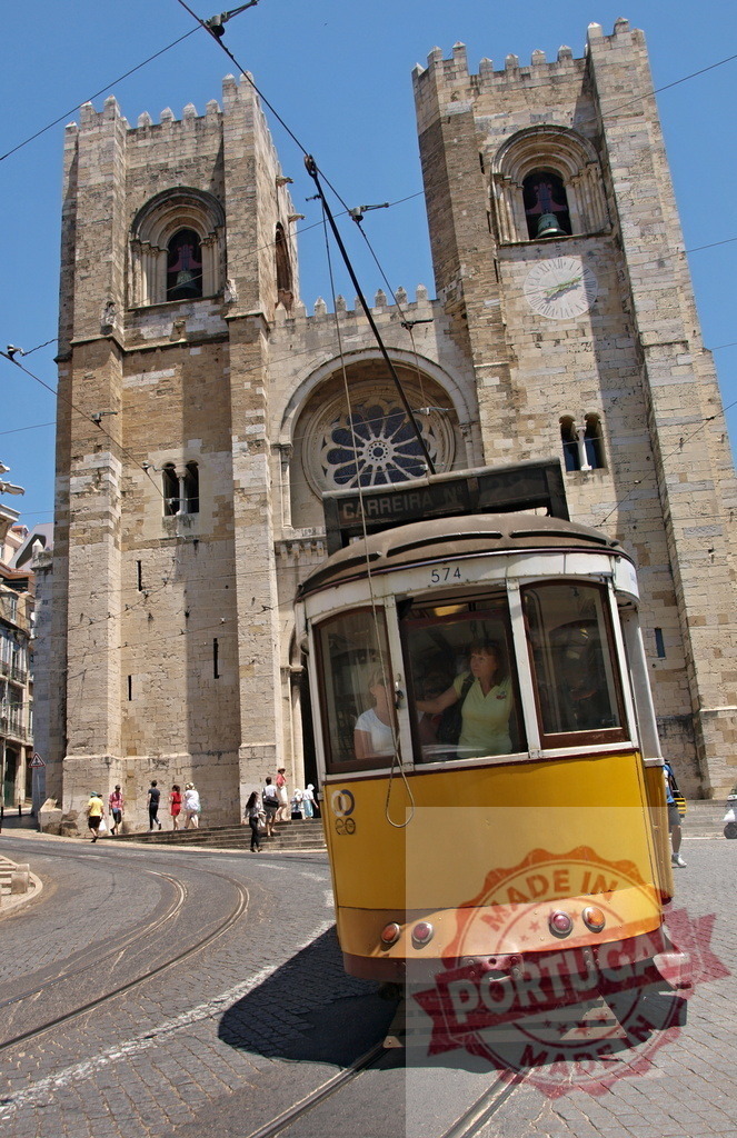 Yellow tram passing in front of Lisbon Cathedral in Portugal | Yellow tram passing in front of Lisbon Cathedral on a summer day - Realized with Pictrs.com