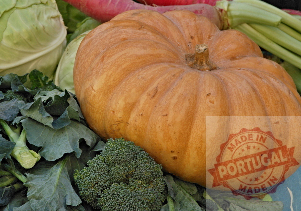 Large pumpkin among fresh organic market vegetables | Pumpkin surrounded by green vegetables, symbolizing autumn harvest and healthy eating - Realized with Pictrs.com