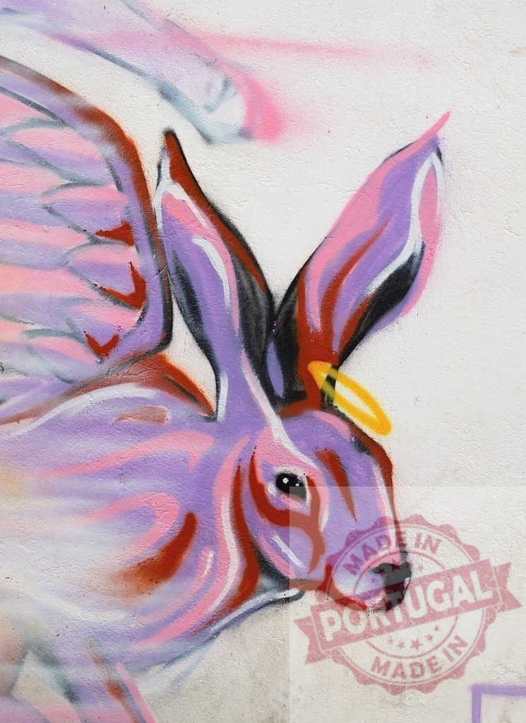 Purple rabbit with wings and halo graffiti | Rabbit character spray painted on a wall, showing wings and a halo - Realisiert mit Pictrs.com