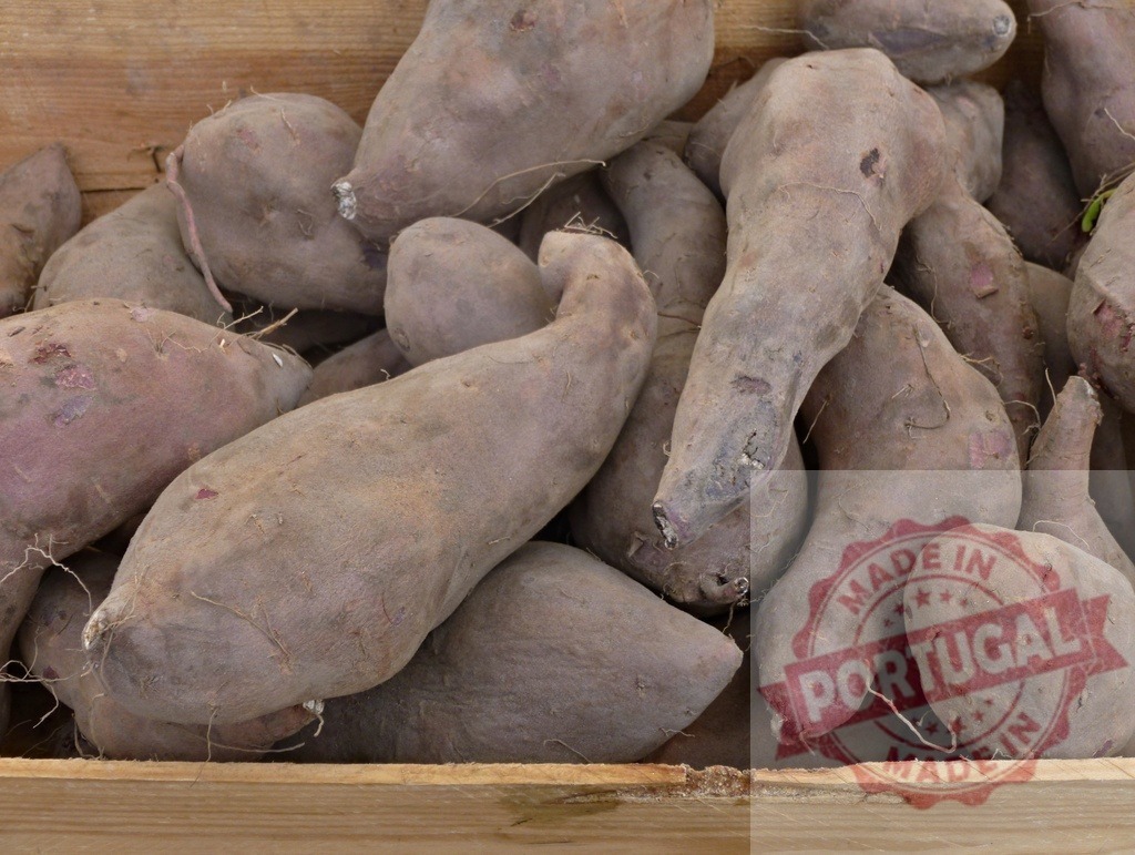 Sweet potatoes tubers for sale in wooden crate | Freshly harvested sweet potatoes filling a rustic wooden crate at a market - Realized with Pictrs.com