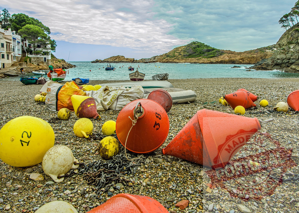 Colorful buoys laying on the beach in a fishing village | Fishing nets and colorful buoys laying on the beach of a fishing village - Realized with Pictrs.com
