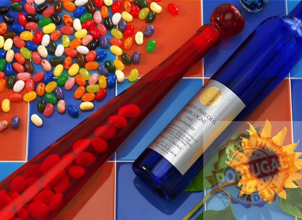 Colorful jelly beans, wine bottle and sunflower still life | Colorful jelly beans mixing with a blue wine bottle and a sunflower on a tiled surface - Realisiert mit Pictrs.com