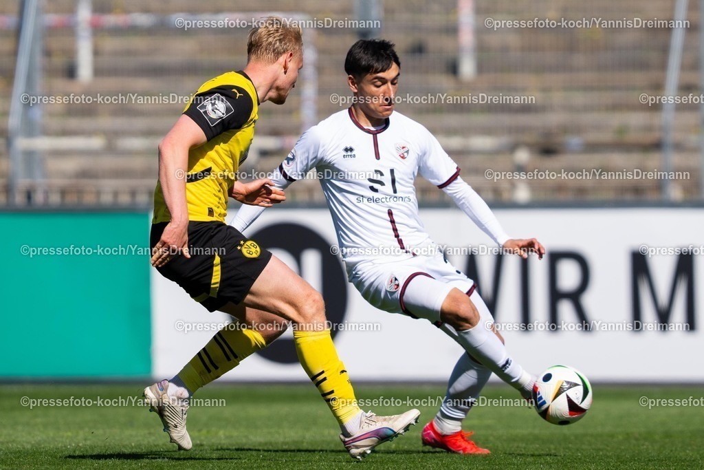 xydr06042501075 | 06.04.2025, xydrx, Fußball, Borussia Dortmund II - FC Ingolstadt 04, 3.Liga, Stadion Rote Erde, Saison 2024 2025: Ben Huening (Borussia Dortmund II #15) im Zweikampf gegen Deniz Zeitler (FC Ingolstadt #38) DFB regulations prohibit any use of photographs as image sequences and or quasi-video.