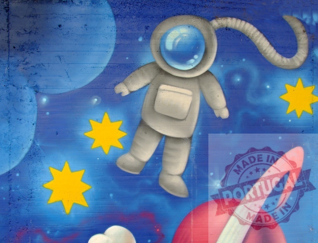 Astronaut floating in graffiti space with planets and stars | Astronaut character floating in a vibrant street art mural of outer space with planets and stars - Realized with Pictrs.com
