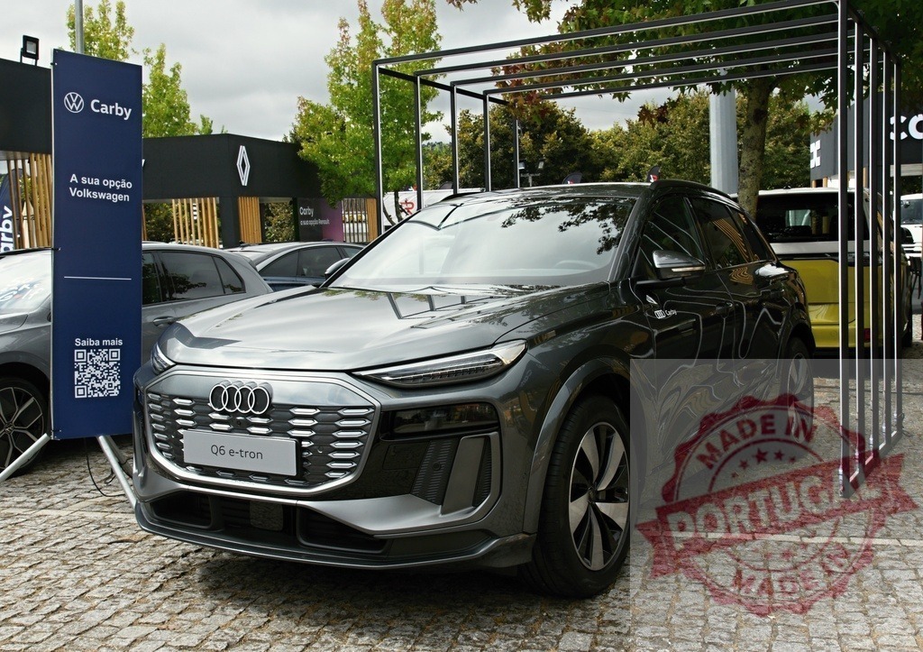 Audi Q6 e-tron electric SUV on display at Carby event | Audi Q6 e-tron showcasing luxury electric SUV technology at an outdoor Carby dealership event - Realized with Pictrs.com