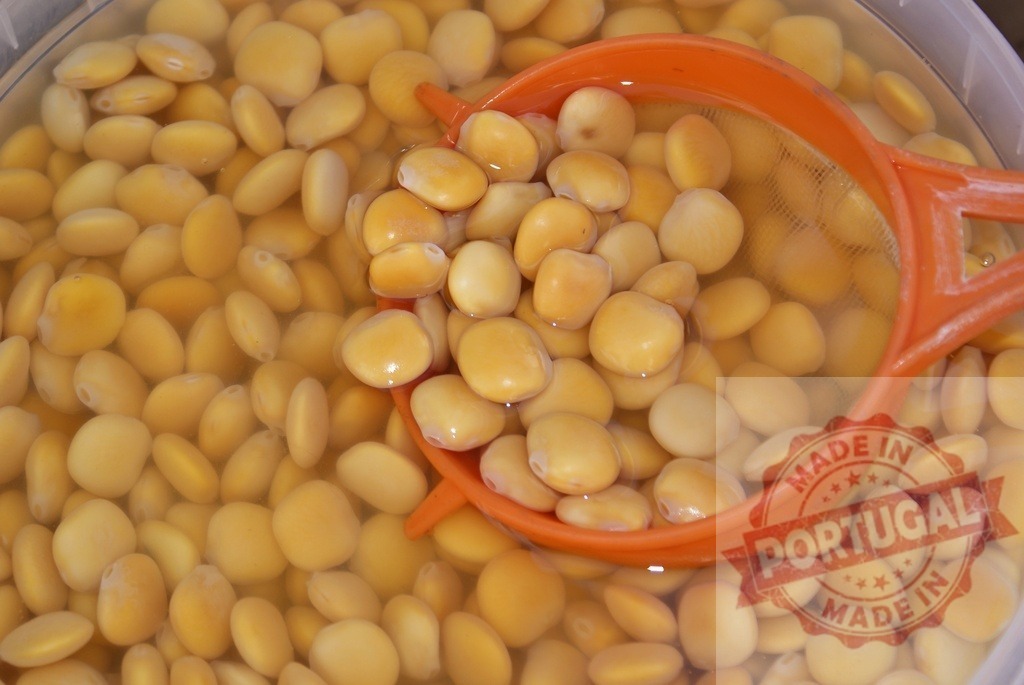 Lupin beans soaking in water with orange strainer | Lupin beans soaking in water, preparing a traditional snack - Realized with Pictrs.com