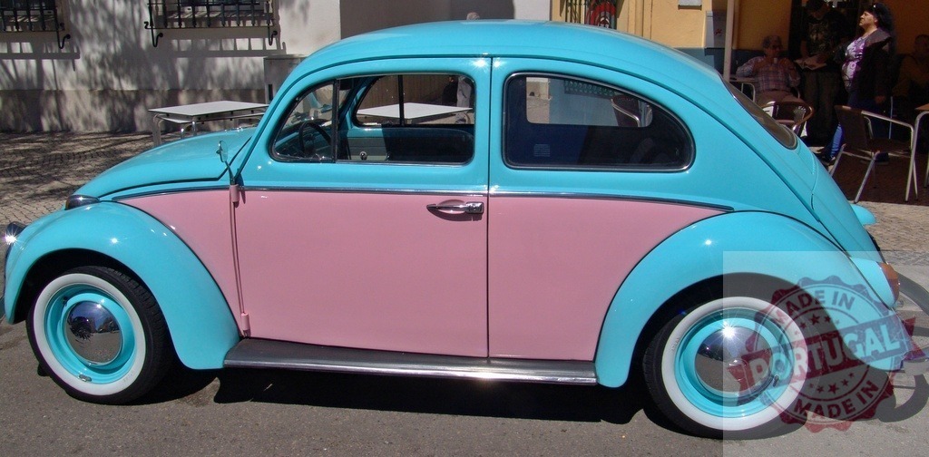 Pink and light blue Volkswagen Beetle parked on a street | Classic Volkswagen Beetle car painted in two-tone pink and turquoise parked on the street - Realized with Pictrs.com