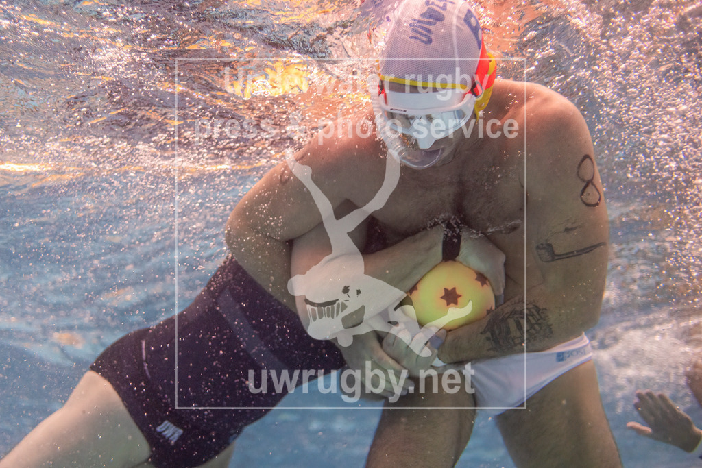 24. - 26.11.2023: Unterwasser-Rugby Champions Cup 2023  | Herren-Spiel: USZ Zürich (Schwiez) in blau gegen Firenze Rugby Sub (Italien) in  weiß. Der Italiener Francesco Bruni (weiß #8) versucht, nahe der Wasseroberfläche, den Schweizer Gegenspieler den Ball zu entreisen. - Realisiert mit Pictrs.com