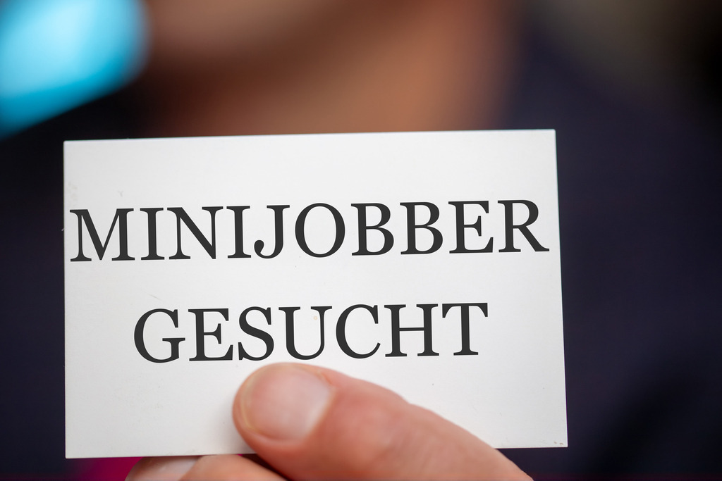 Minijobber gesucht: Mann hält eine Visitenkarte mit (hinzugefügtem) Text MINIJOBBER GESUCHT in der Hand (Symbolbild) | Minijobber gesucht: Mann hält eine Visitenkarte mit (hinzugefügtem) Text MINIJOBBER GESUCHT in der Hand (Symbolbild) - Realisiert mit Pictrs.com