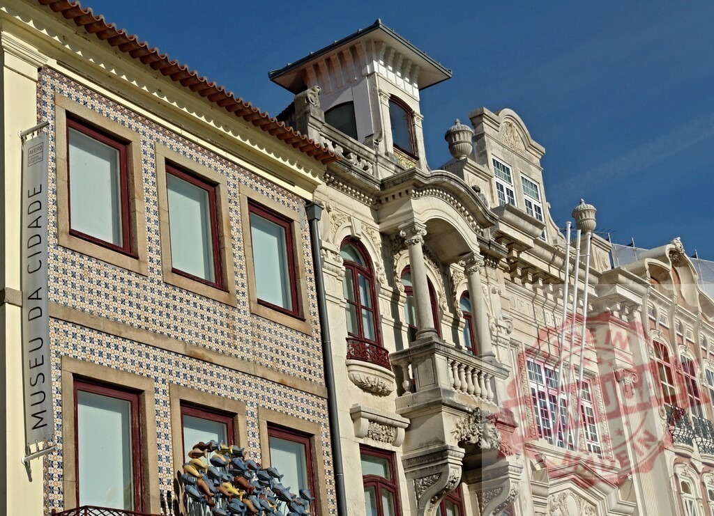 Museu da Cidade Aveiro building exterior facade architecture | Aveiro, Portugal building exterior showing ornate architecture, azulejo tiles, and a balcony on a sunny day - Realized with Pictrs.com