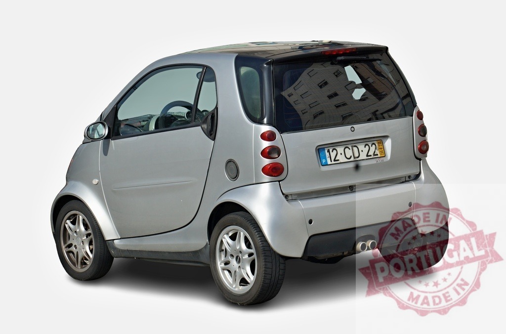 Smart Fortwo coupé car parked on white background | Silver Smart Fortwo coupé city car parked on a white background, showcasing its compact design - Realized with Pictrs.com