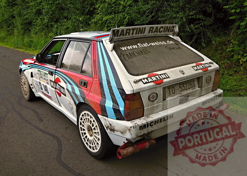 Lancia Delta Integrale Martini Racing rally car on road | Dirty Lancia Delta Integrale Martini Racing rally car resting on a dark road after a race - Realized with Pictrs.com